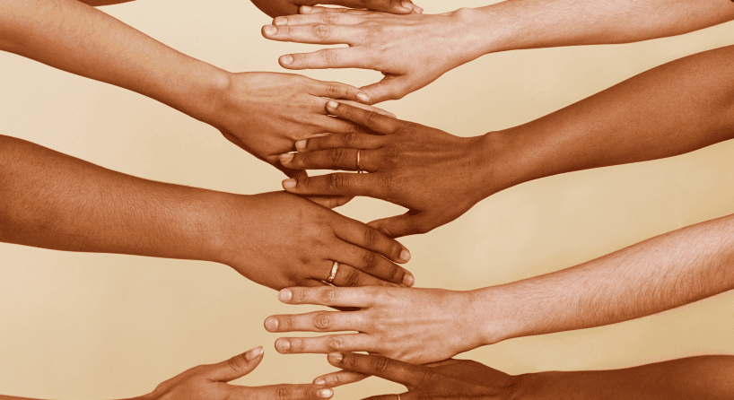 A number of people with their arms stretched out of varying skin tones.